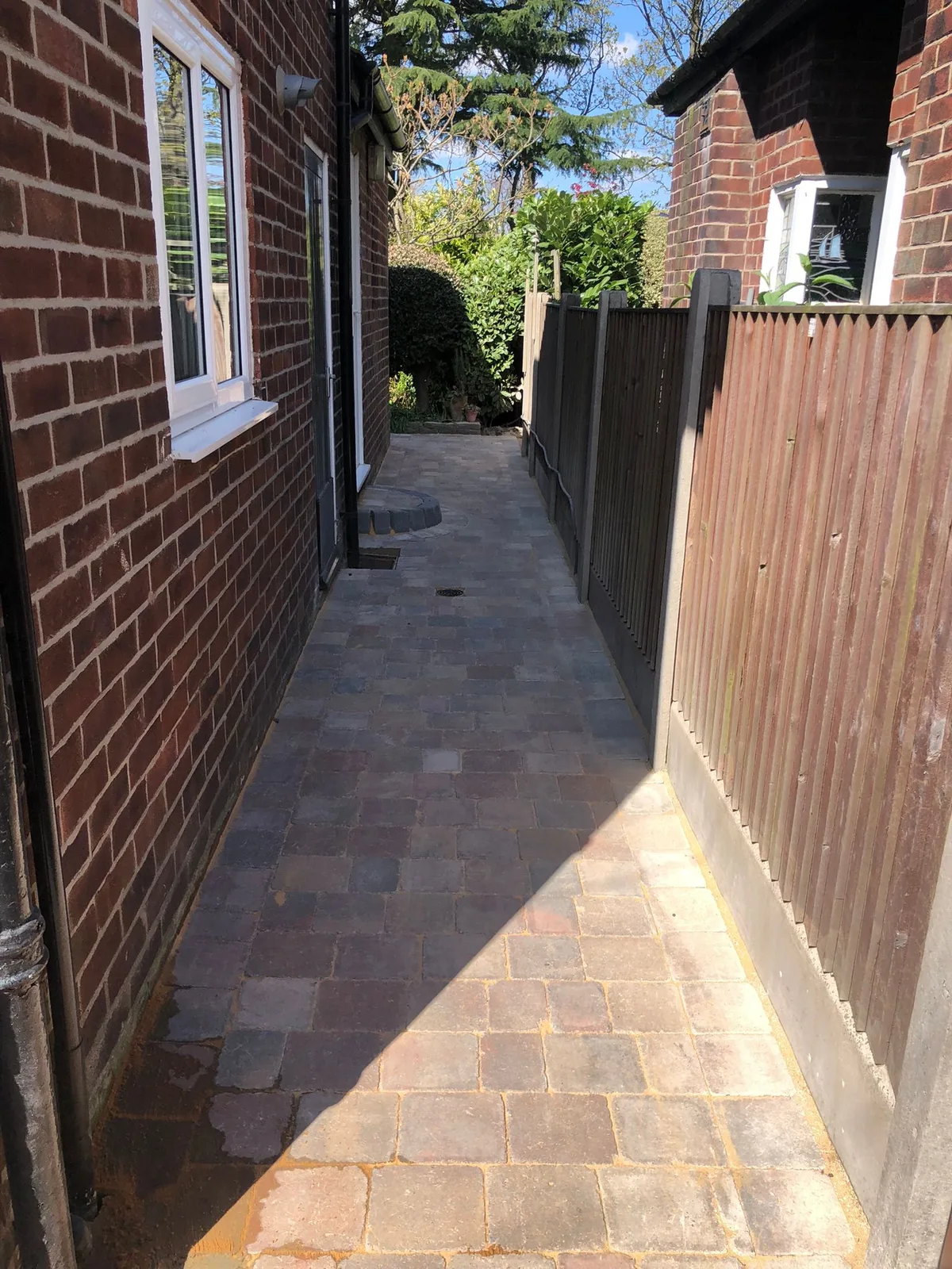 Block paving side passage between houses - Manchester