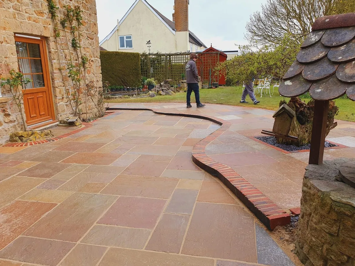 Indian sandstone patio installation in progress - A.L. Landscapes Manchester